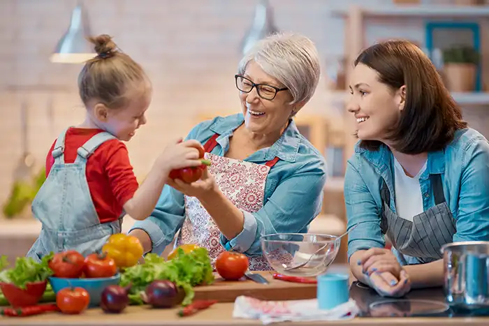 mother grandmother and granddaughter in the kitchen