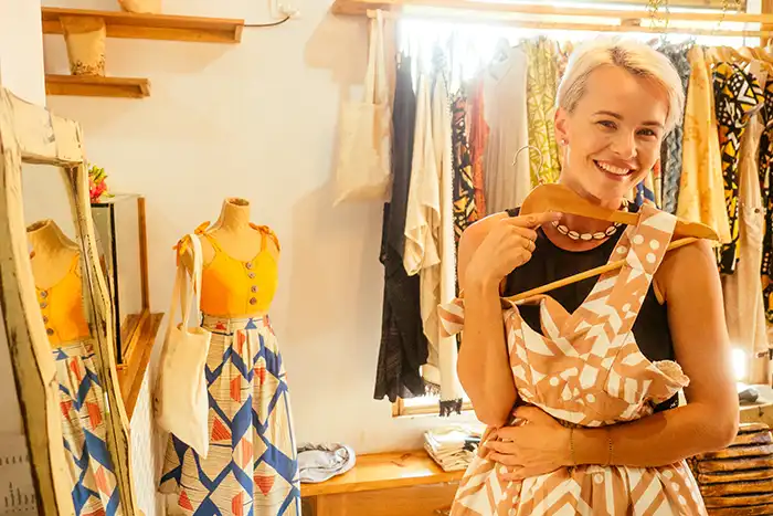 Rediscover Joy with Italy's Slow Fashion Revolution. 8 woman try vintage dress in a boutique