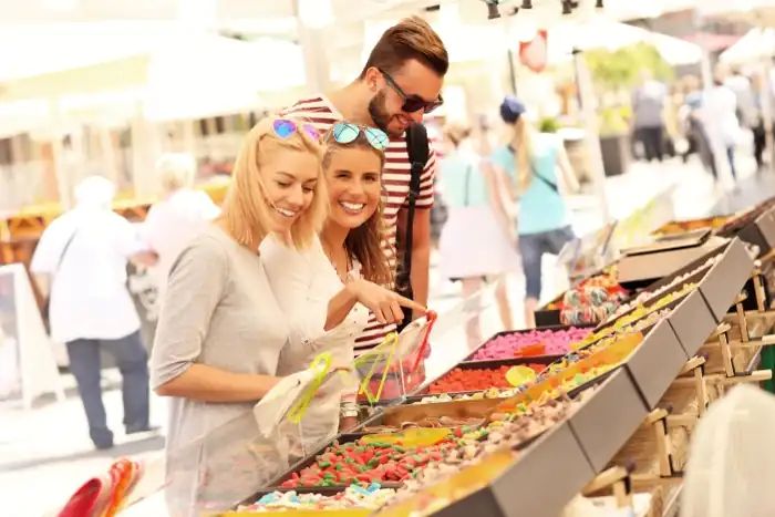 Celebrate the Euphoria of Italy's Summer Events and Celebrations 9 Friends buying candies