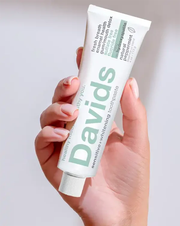 woman hand with Davids Hydroxyapatite Toothpaste