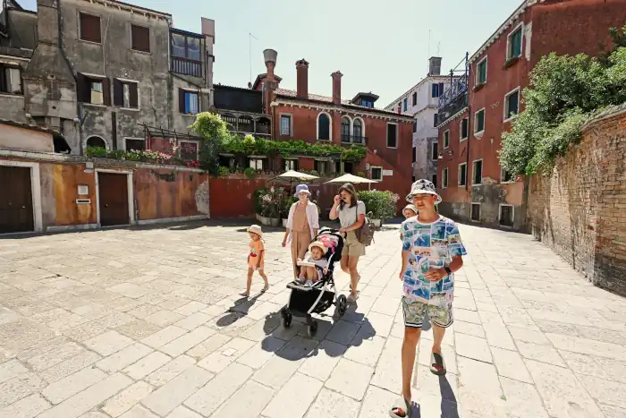 woman with kids walk in campiello novo Venice