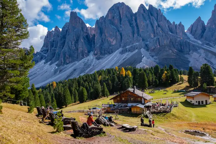 Autumn day in the Dolomites with rustic cottage