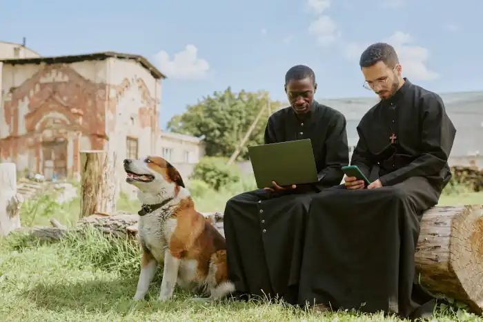 Feast of Sant’Antonio Abate: Italy’s Animal Blessing Day 7 priests sitting together outsidewith dog
