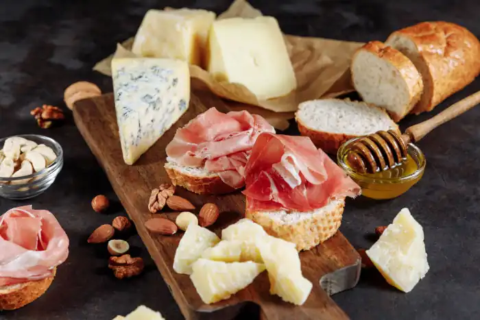 Cheese, prosciutto with bread, honey and nuts