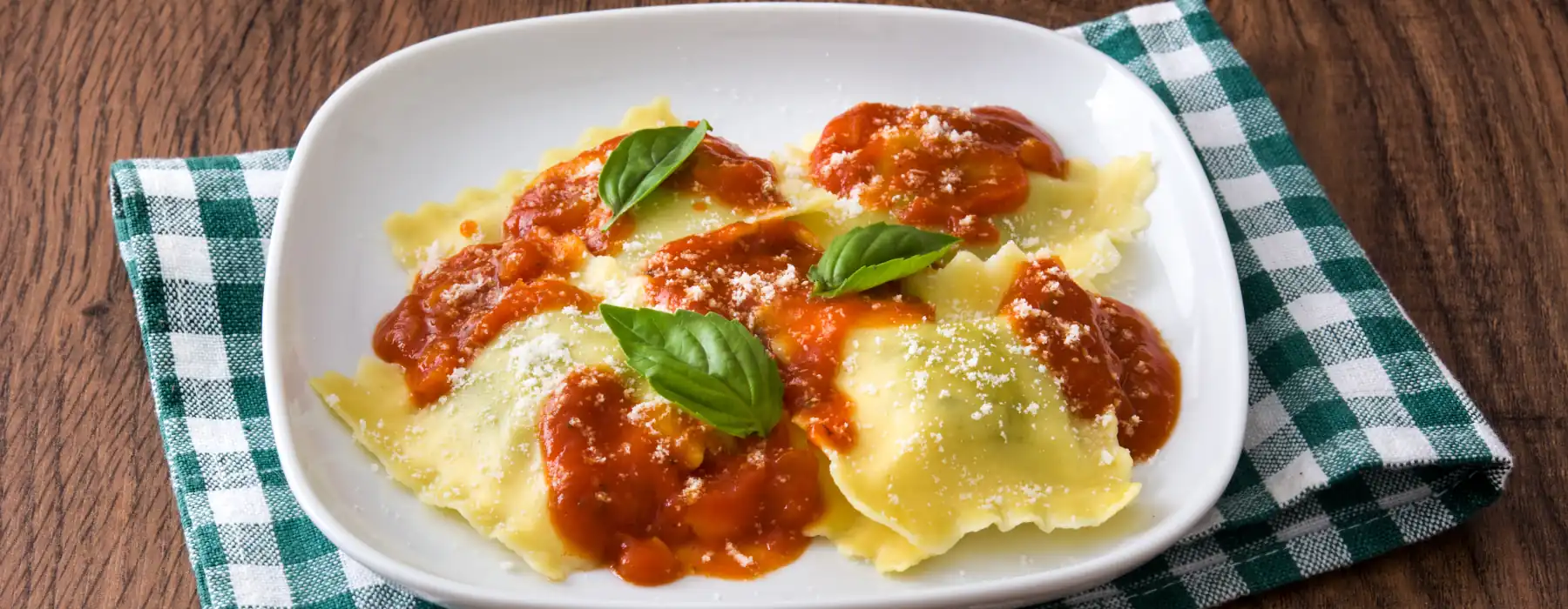 Cozy Up with Italian Winter Culinary Traditions, ravioli with tomato sauce grated cheese and basil
